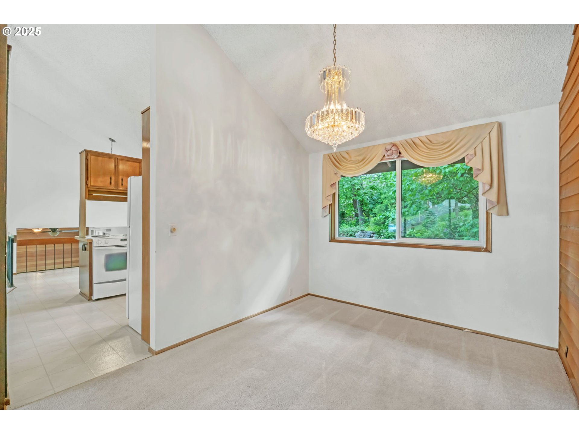 2811 Greentree Way Eugene, OR 97405 - Photo 8 of 38 a view of empty room with window and kitchen view