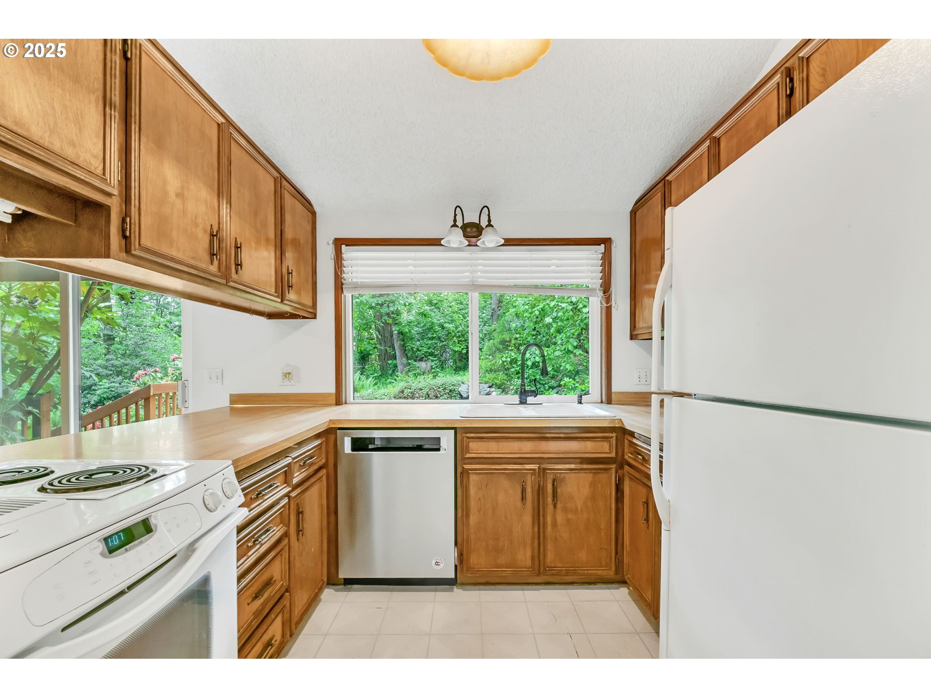 2811 Greentree Way Eugene, OR 97405 - Photo 10 of 38 a kitchen with a stove a sink and a refrigerator