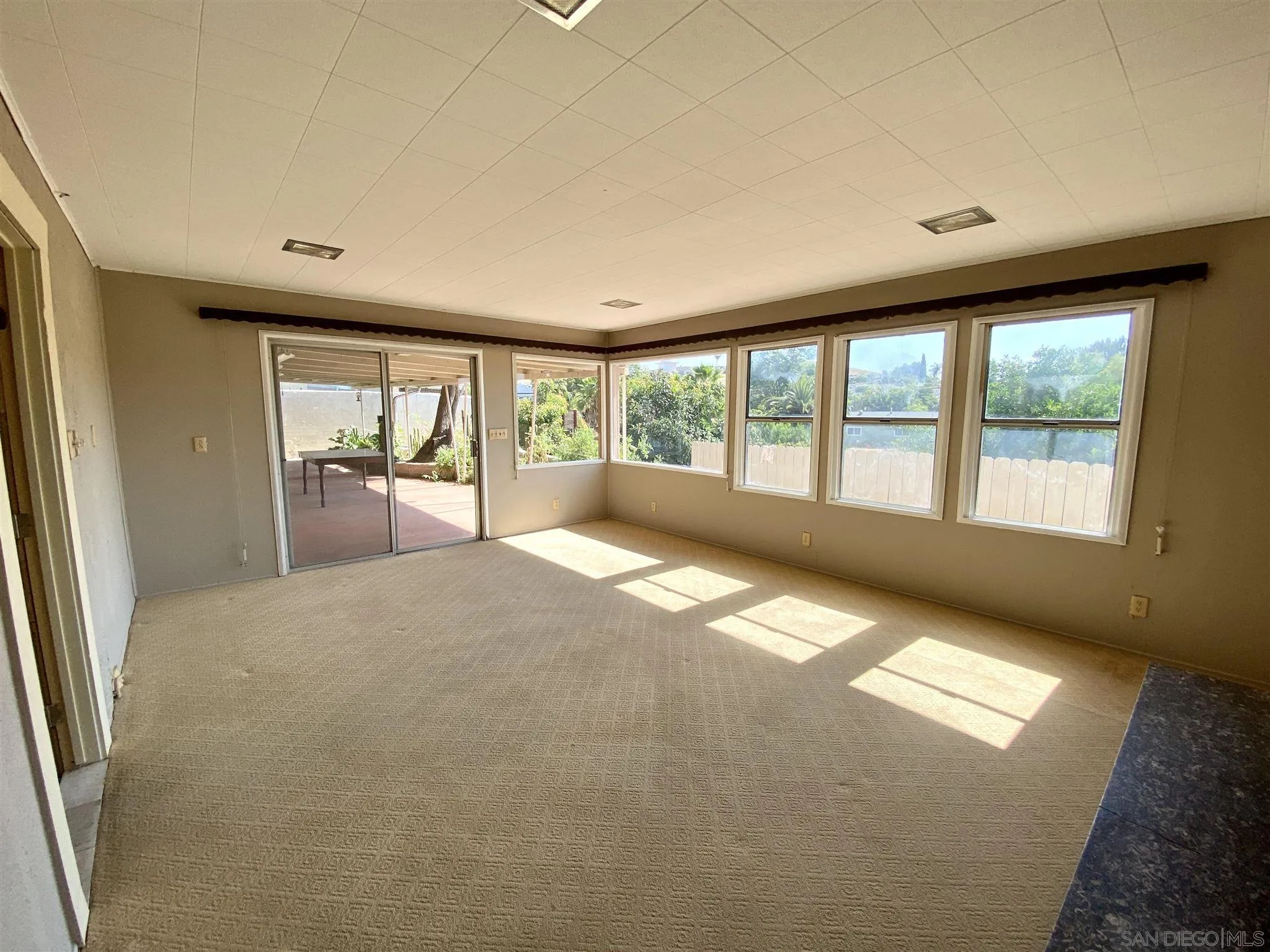 9609 Vomac Road Santee, CA 92071 - Photo 3 of 10 a view of empty room with wooden floor and fan