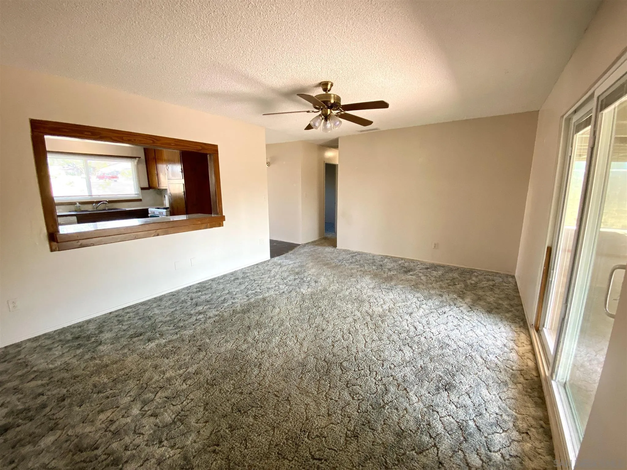 9609 Vomac Road Santee, CA 92071 - Photo 8 of 10 a view of a livingroom with a ceiling fan and window