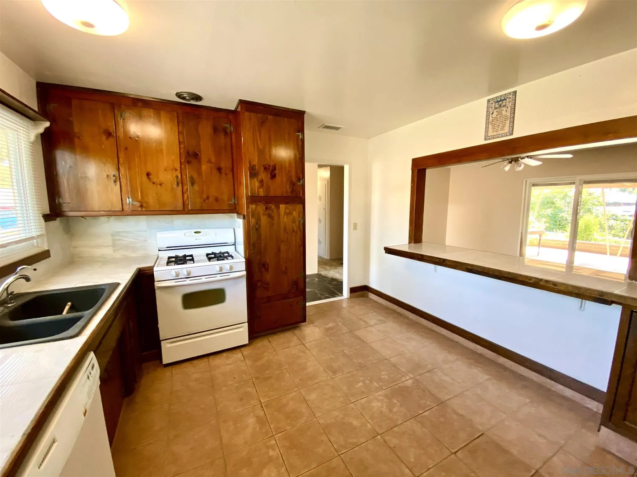 9609 Vomac Road Santee, CA 92071 - Photo 10 of 10 a kitchen with a stove and a refrigerator