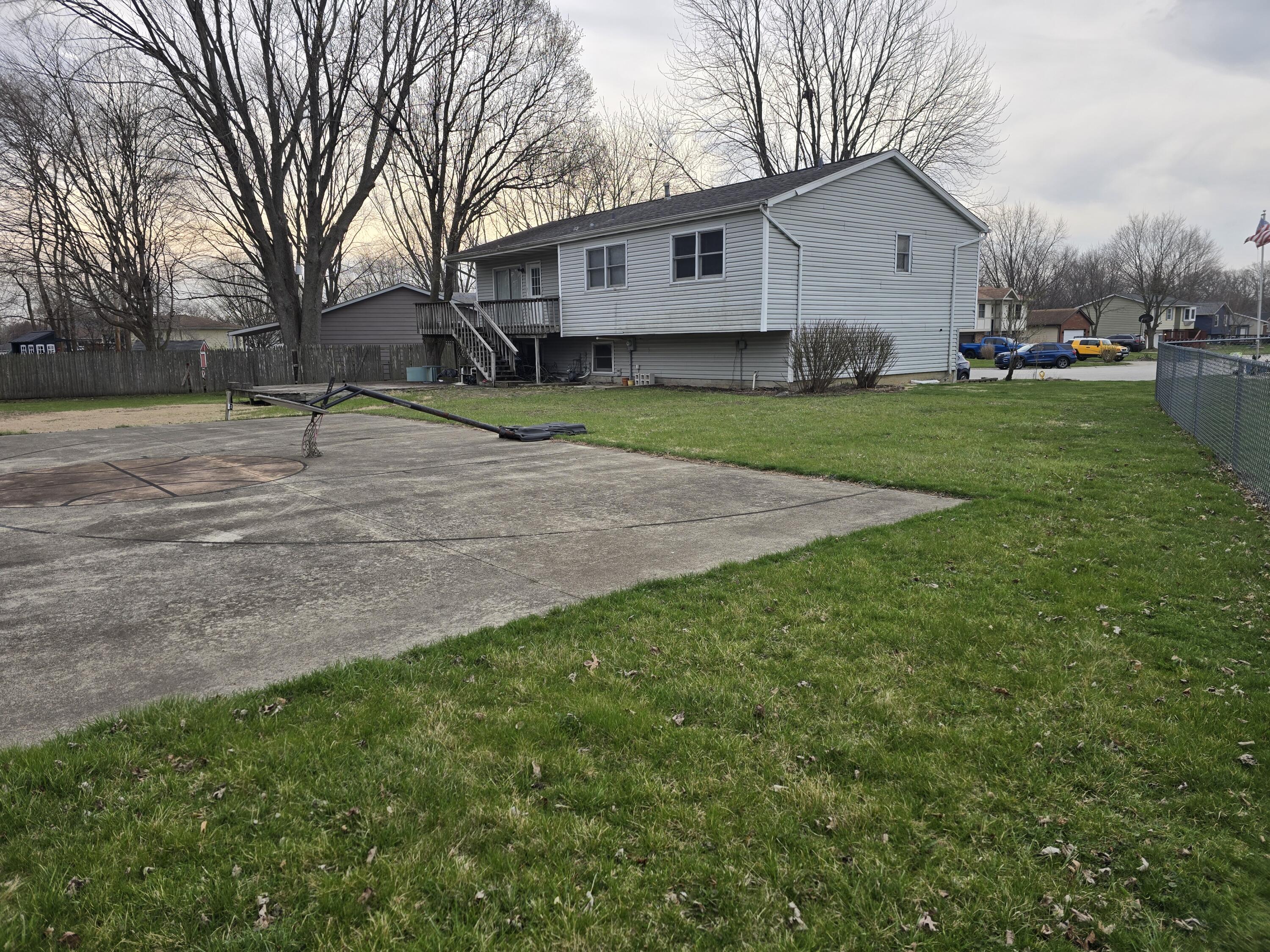 79 Maple Court Hebron, IN 46341 - Photo 21 of 22 a view of a yard in front of a house with large tree