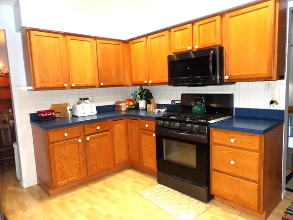 a kitchen with stainless steel appliances a stove a sink and a microwave
