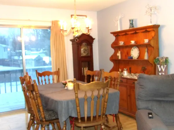 a view of a dining room with furniture and chandelier