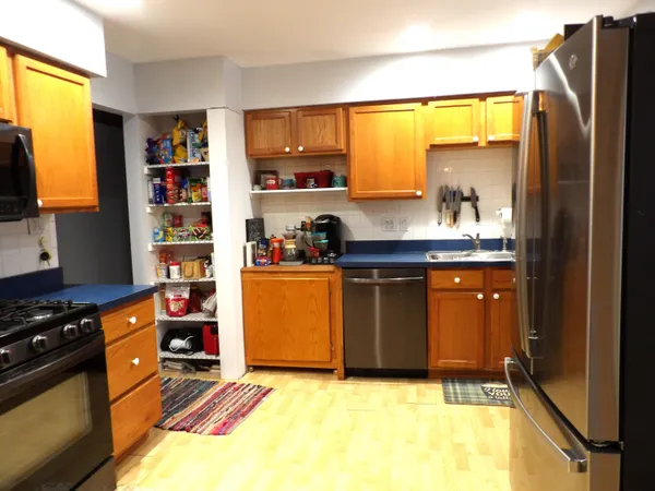 a kitchen with stainless steel appliances granite countertop a refrigerator and a sink