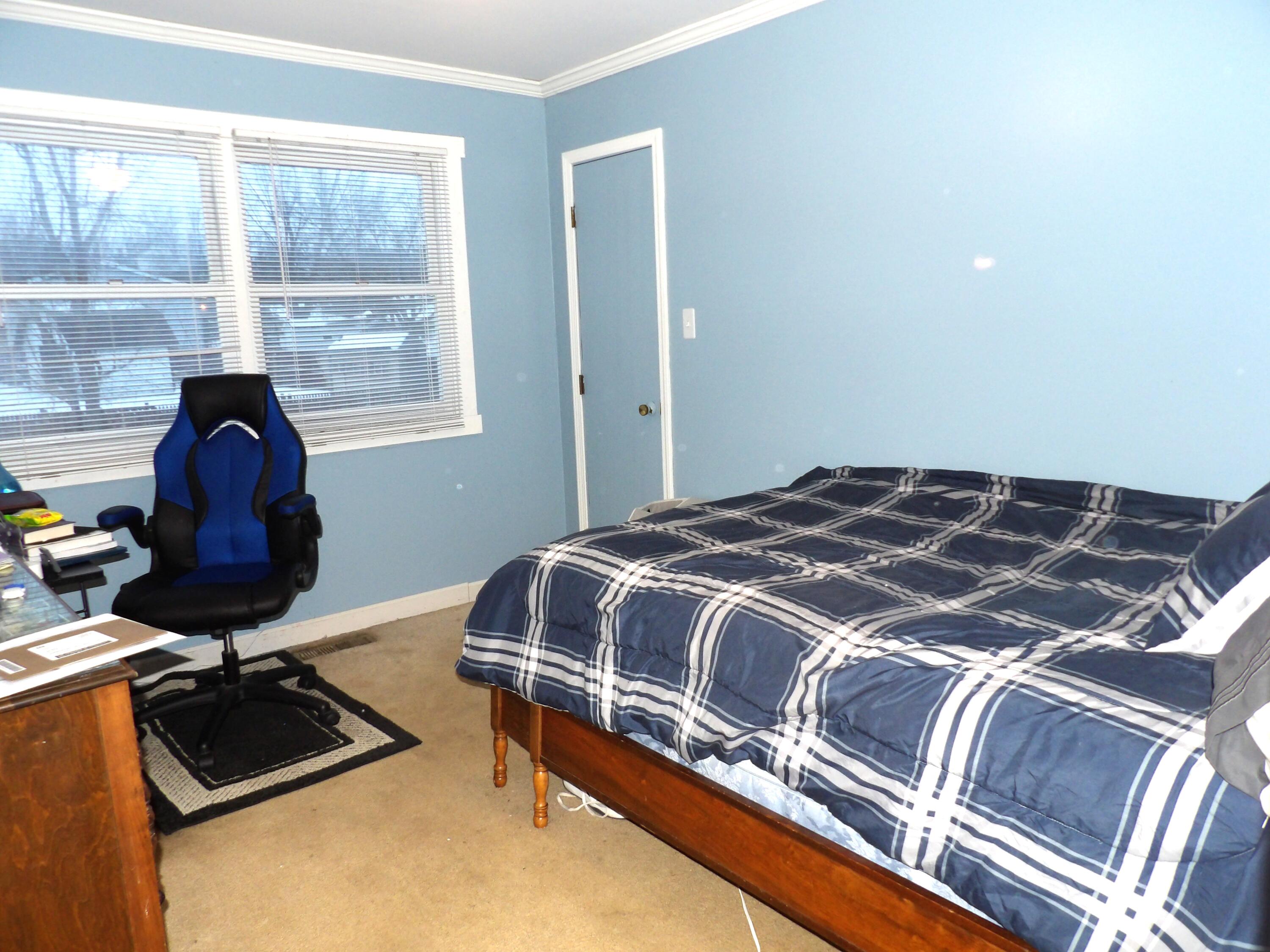 79 Maple Court Hebron, IN 46341 - Photo 8 of 19 a bedroom with a bed and a window