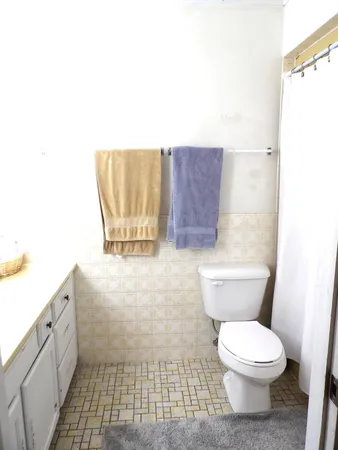 a white toilet sitting next to a white sink