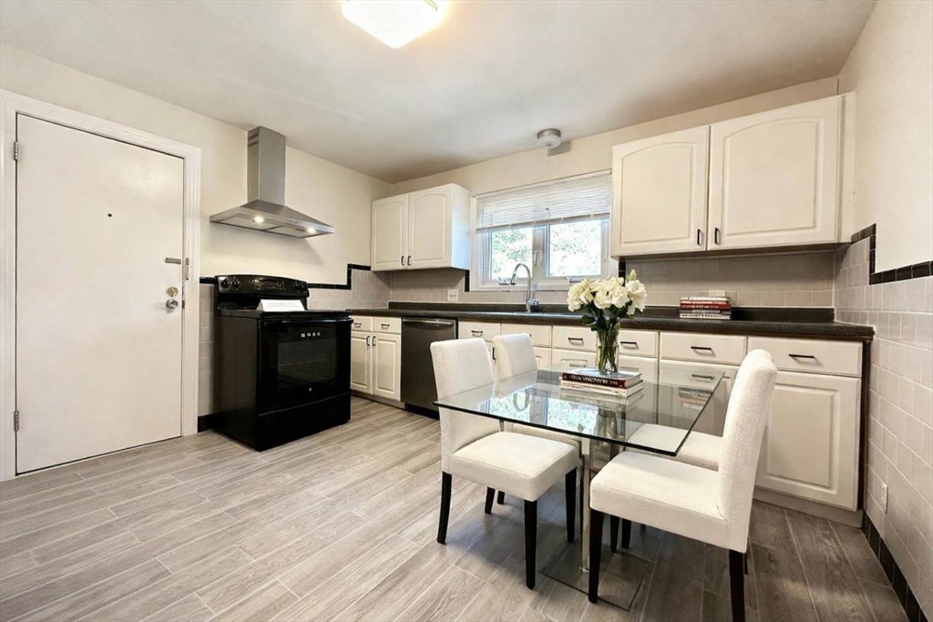 110 Craftsland Road, Unit 110 Newton, MA 02467 - Photo 1 of 14 a kitchen with stainless steel appliances granite countertop a dining table chairs refrigerator and sink