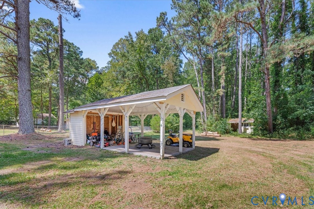 2224 Butler Branch Road Petersburg, VA 23805 - Photo 17 of 24 a view of a patio with table and chairs next to a yard