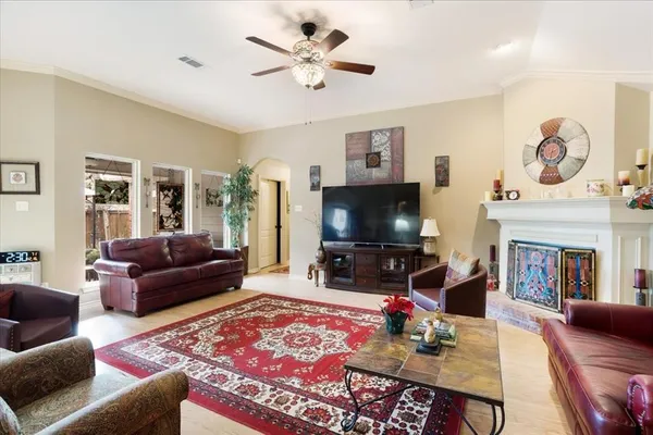 a living room with furniture a flat screen tv and a fireplace