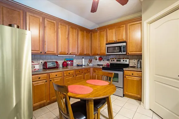 a kitchen with stainless steel appliances granite countertop a refrigerator a stove top oven a sink and dishwasher