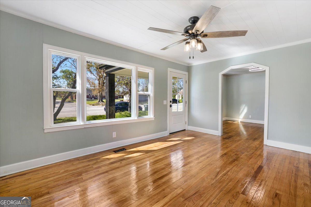360 North Lewis Street Metter, GA 30439 - Photo 11 of 39 a view of an empty room with wooden floor and a window