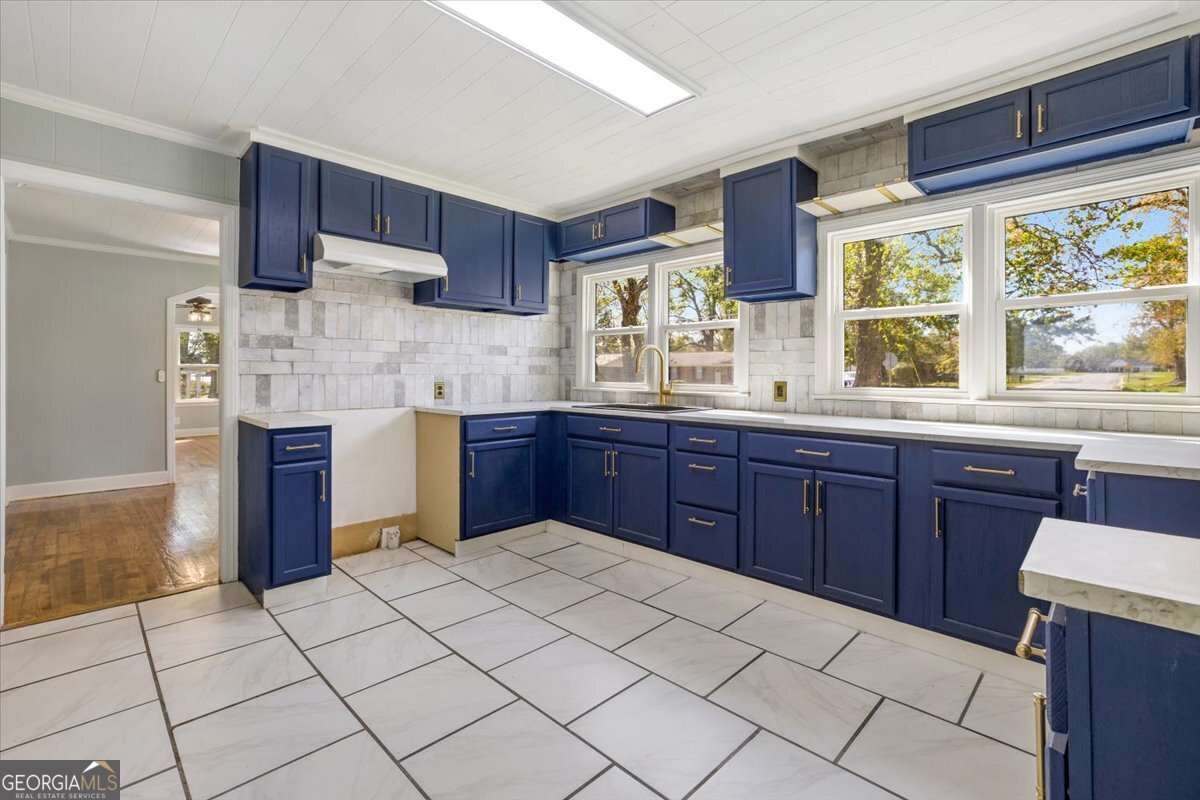 360 North Lewis Street Metter, GA 30439 - Photo 17 of 39 a kitchen with stainless steel appliances granite countertop a sink window and cabinets