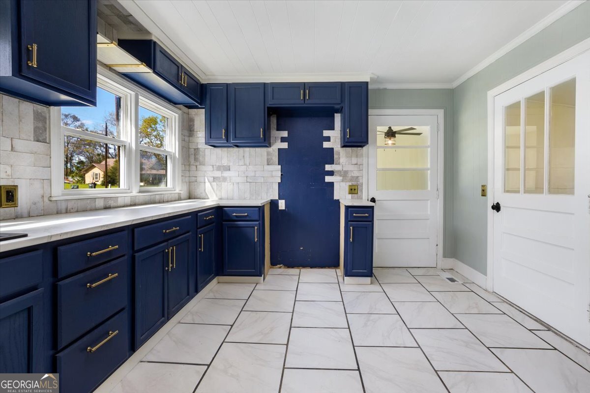 360 North Lewis Street Metter, GA 30439 - Photo 19 of 39 a kitchen with stainless steel appliances granite countertop a refrigerator and a sink