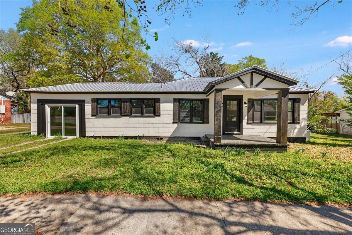 360 North Lewis Street Metter, GA 30439 - Photo 2 of 39 a front view of a house with a garden