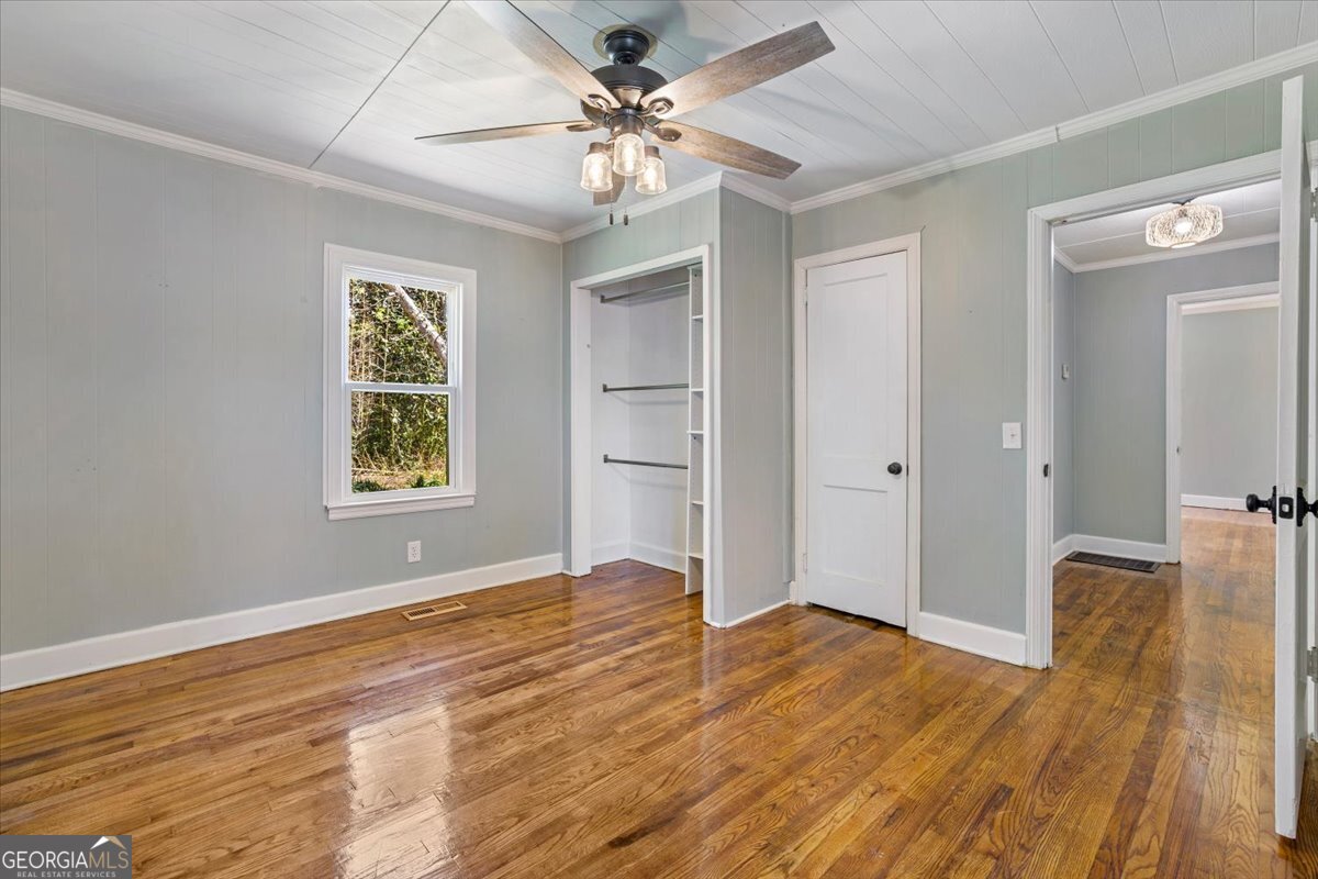 360 North Lewis Street Metter, GA 30439 - Photo 22 of 39 a view of an empty room with window and wooden floor
