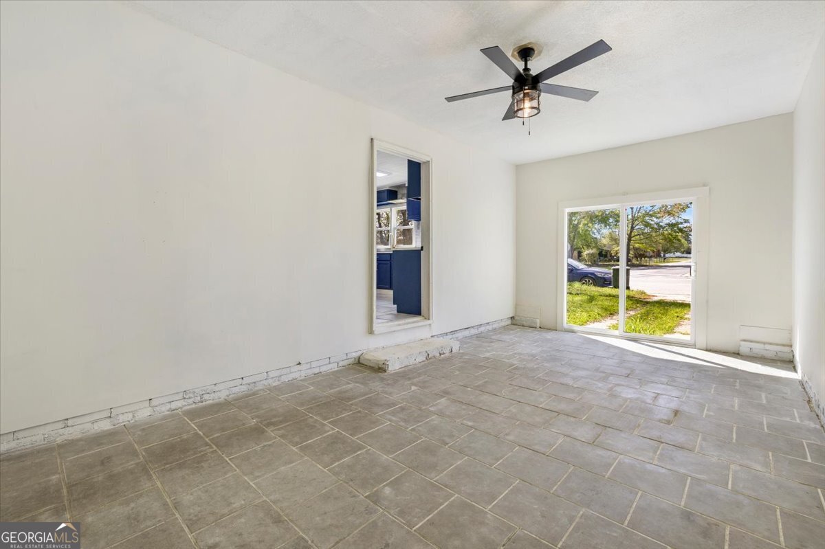 360 North Lewis Street Metter, GA 30439 - Photo 30 of 39 an empty room with a ceiling fan and window
