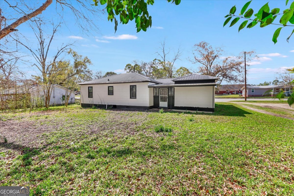 360 North Lewis Street Metter, GA 30439 - Photo 38 of 39 a view of a house with a backyard
