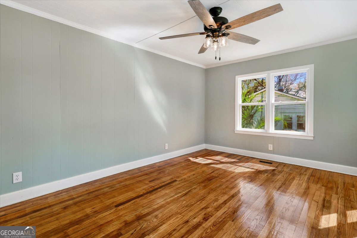 360 North Lewis Street Metter, GA 30439 - Photo 9 of 39 wooden floor in an empty room with a window