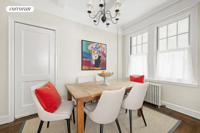 a view of a dining room with furniture a chandelier and wooden floor