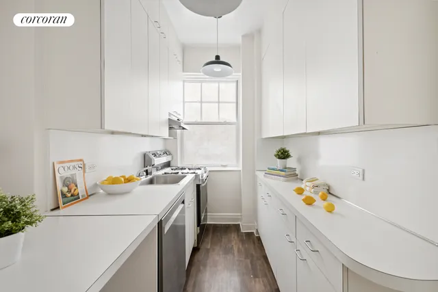 a utility room with cabinets washer and dryer