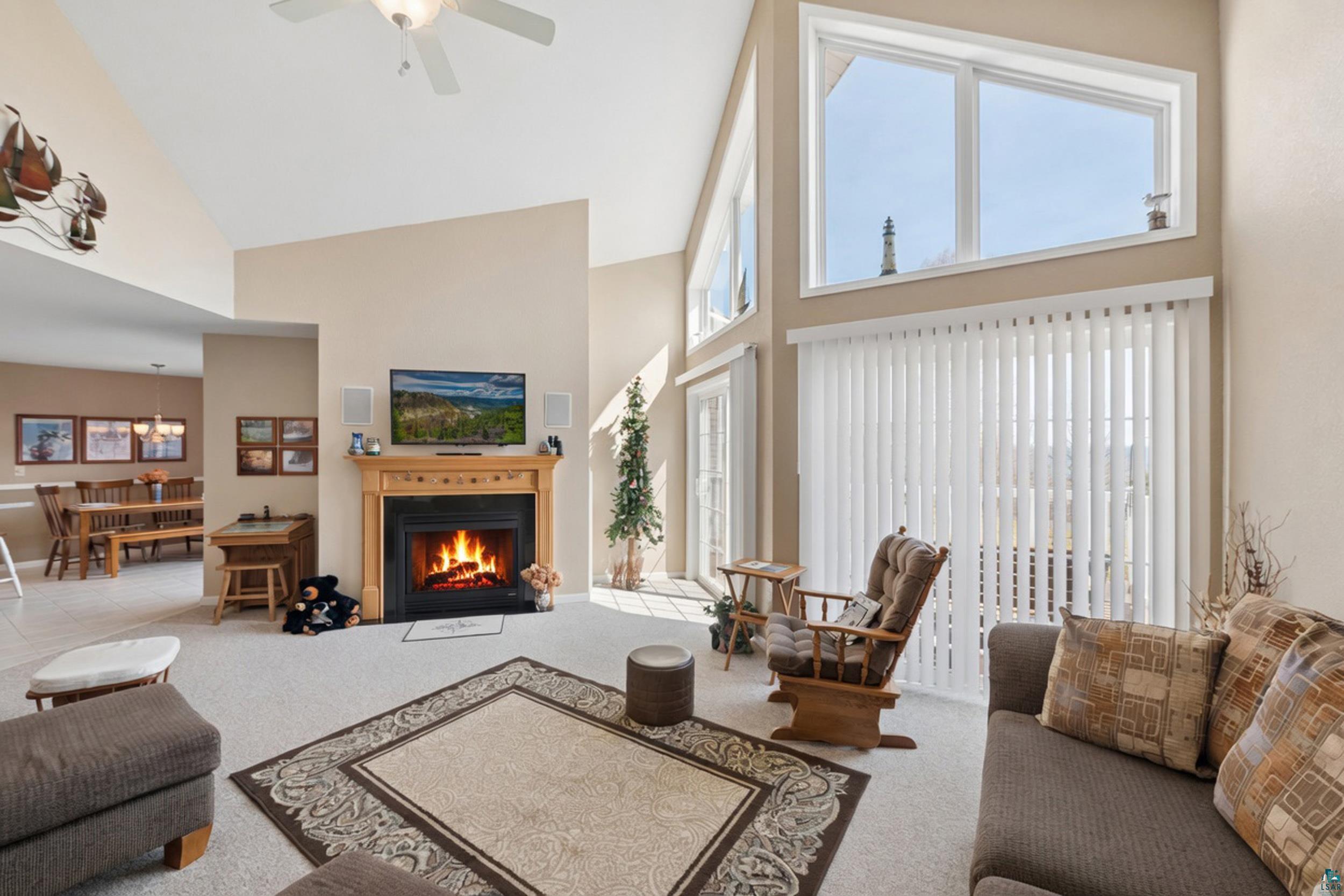 34590 Bay View Road, Unit 801 Bayfield, WI 54814 - Photo 9 of 36 Living room with vaulted ceiling, large vertical blinds, and upper transom windows