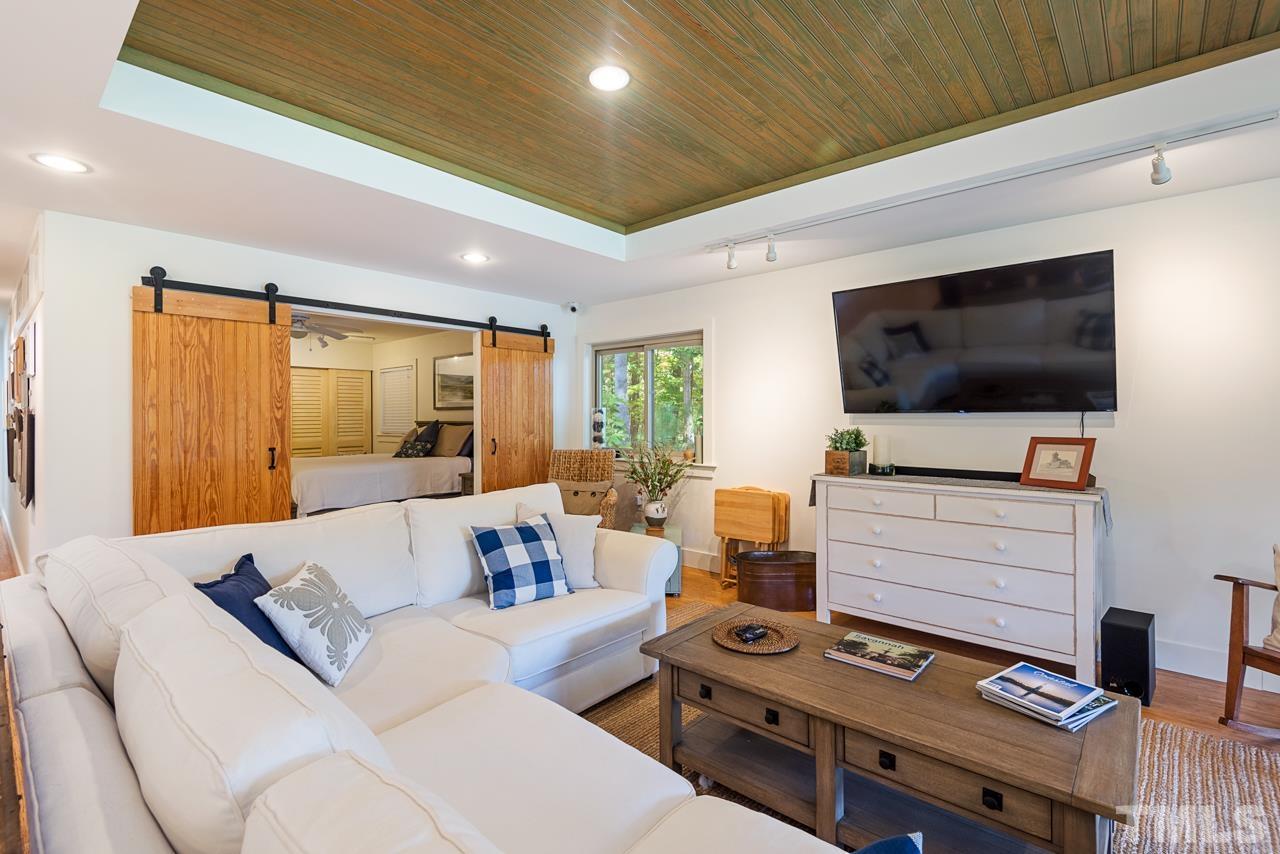 2639 Umstead Road Durham, NC 27712 - Photo 13 of 42 a living room with furniture and a flat screen tv