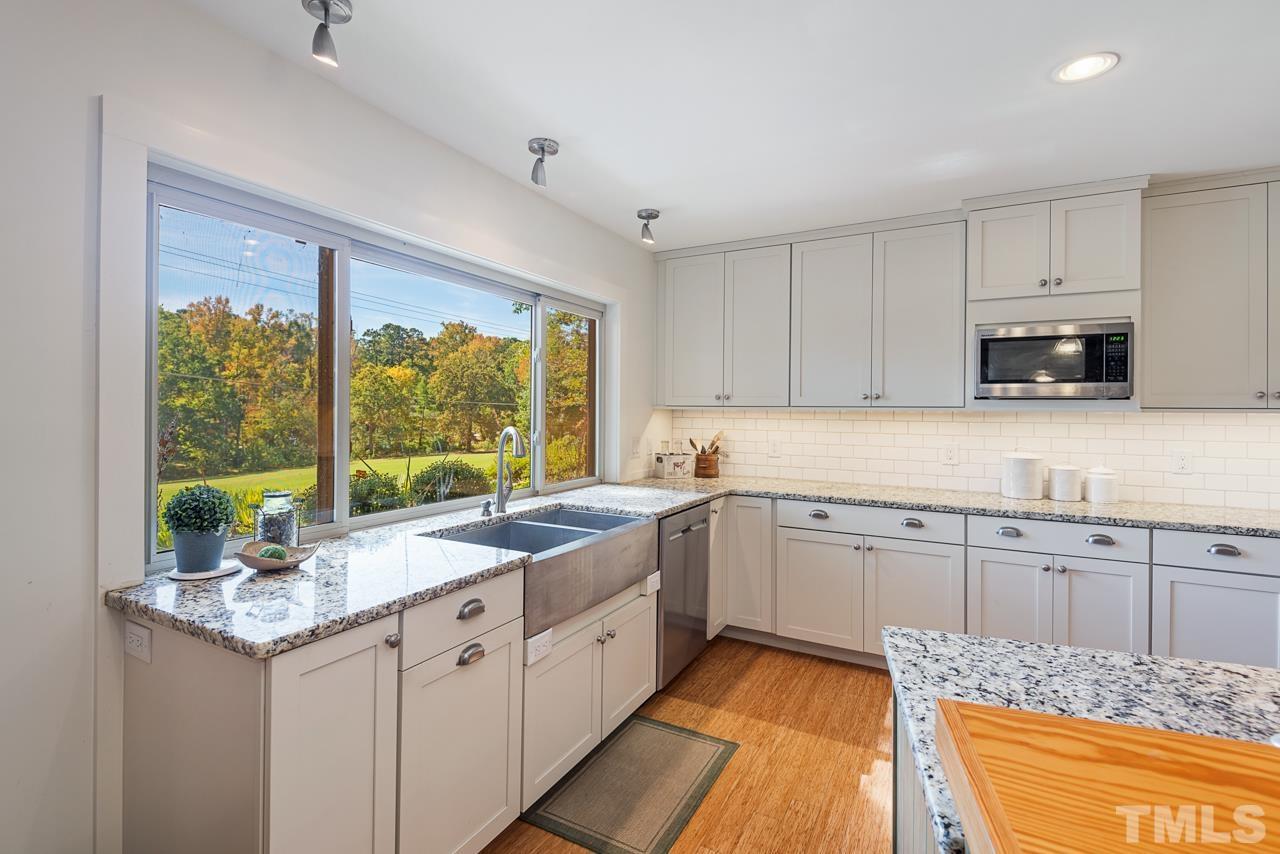 2639 Umstead Road Durham, NC 27712 - Photo 19 of 42 a kitchen with sink cabinets and appliances