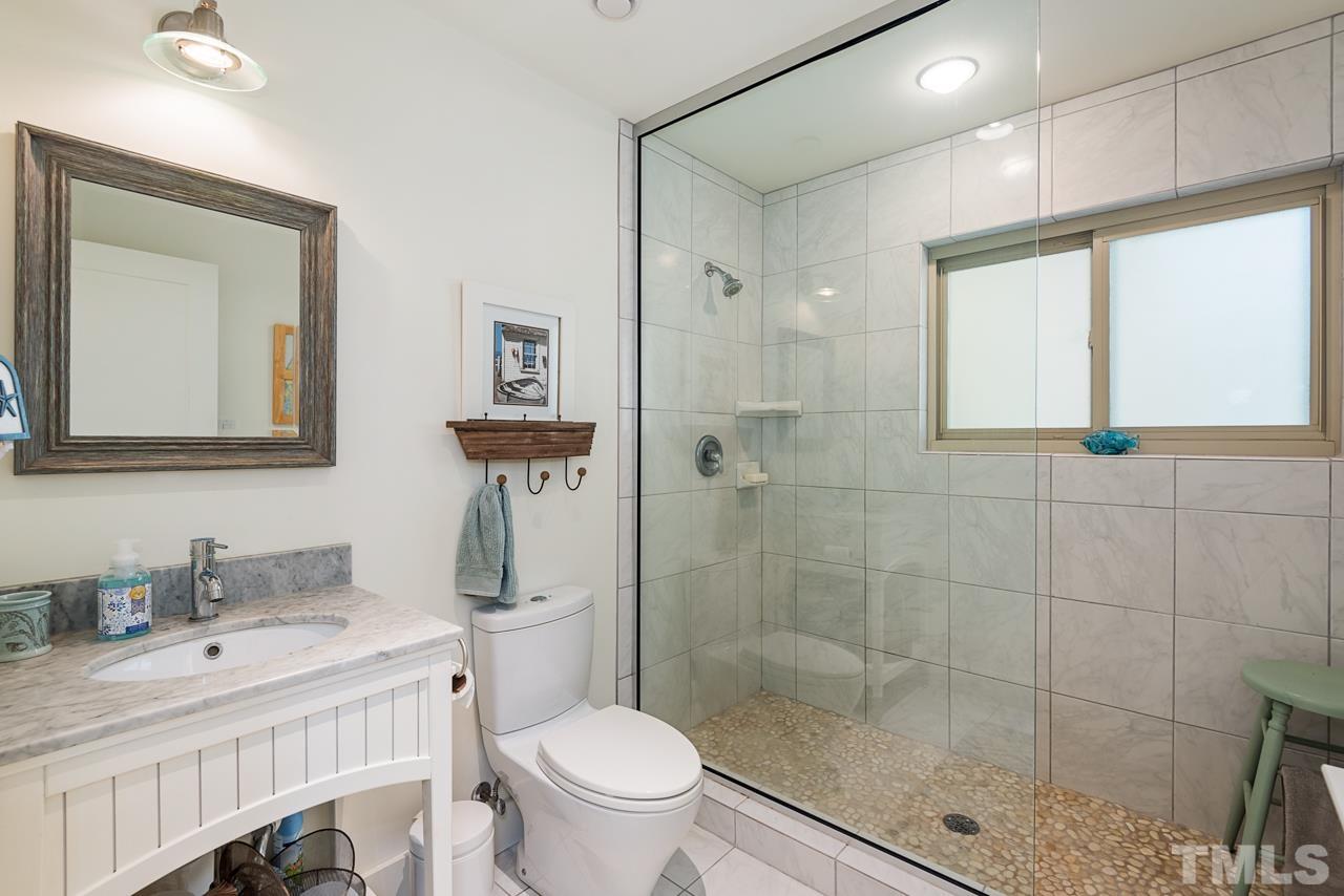 2639 Umstead Road Durham, NC 27712 - Photo 26 of 42 a bathroom with a sink a toilet and shower