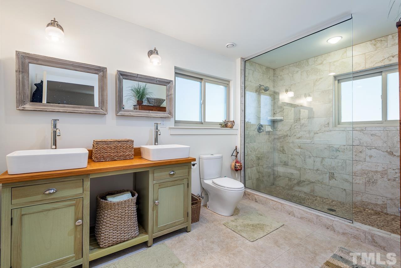 2639 Umstead Road Durham, NC 27712 - Photo 28 of 42 a bathroom with a toilet sink a mirror and shower