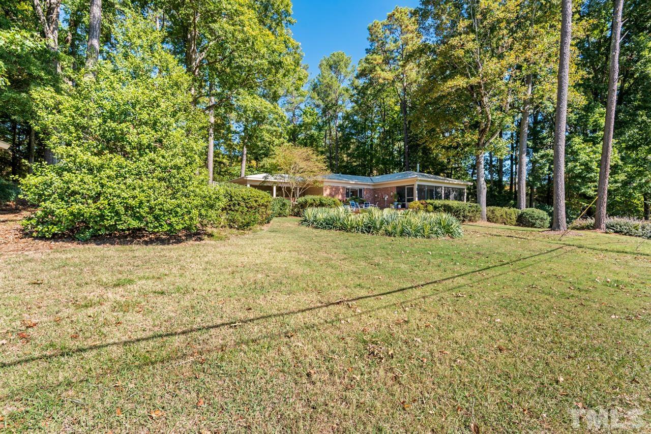 2639 Umstead Road Durham, NC 27712 - Photo 40 of 42 a view of an house with backyard and trees