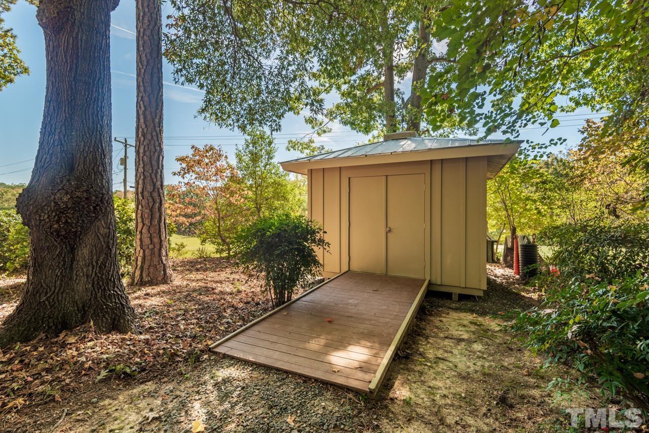 2639 Umstead Road Durham, NC 27712 - Photo 42 of 42 a view of a backyard with plants and large tree