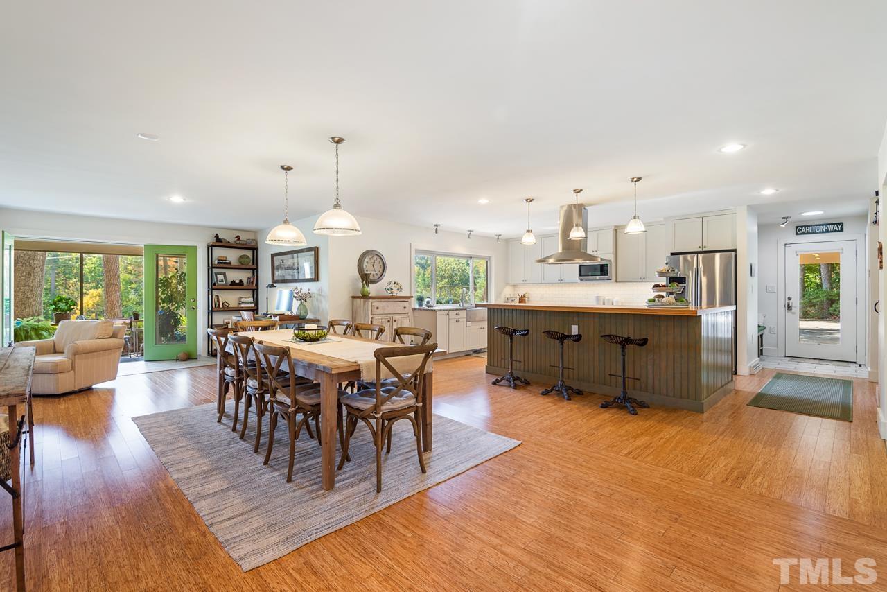 2639 Umstead Road Durham, NC 27712 - Photo 10 of 42 a living room with stainless steel appliances kitchen island granite countertop a table chairs and a view of living room