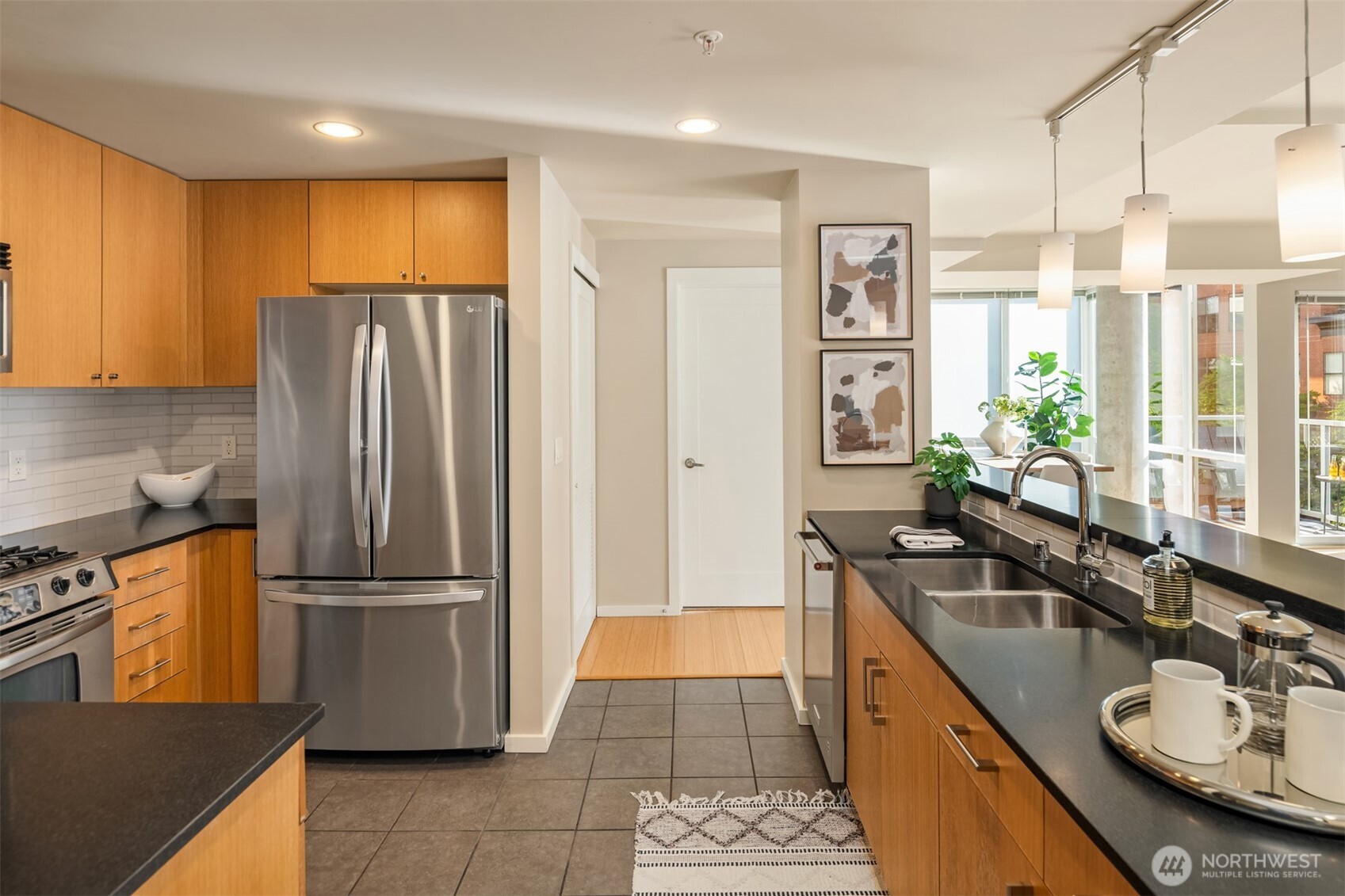 76 Cedar Street, Unit 609 Seattle, WA 98121 - Photo 6 of 31 a kitchen with granite countertop a refrigerator and a sink