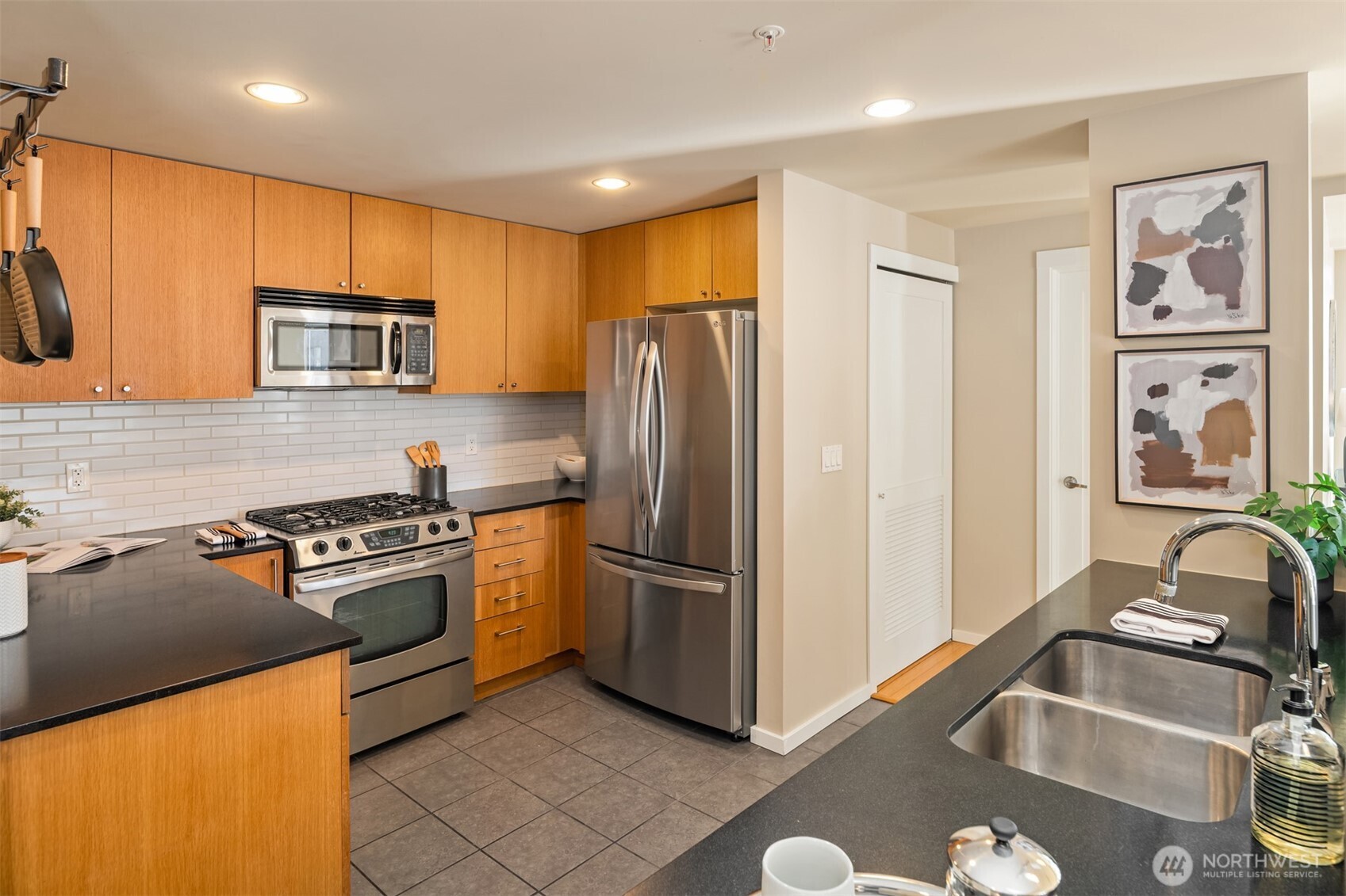 76 Cedar Street, Unit 609 Seattle, WA 98121 - Photo 7 of 31 a kitchen with stainless steel appliances granite countertop a refrigerator stove and sink