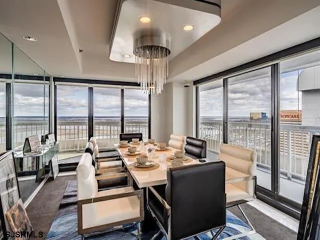 a room with furniture water view and large windows