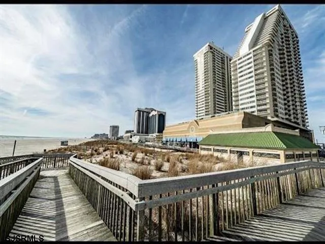 a roof deck with a barbeque and wooden floor
