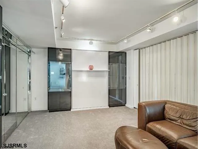 a living room with furniture and a cabinet