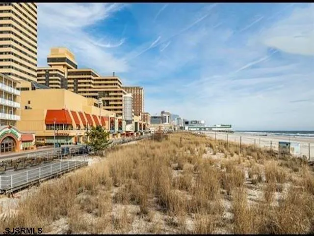 a view of a yard with wooden fence