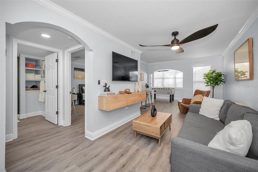 19417 Gulf Boulevard, Unit F207 Indian Rocks Beach, FL 33785 - Photo 17 of 56 a living room with furniture and a flat screen tv