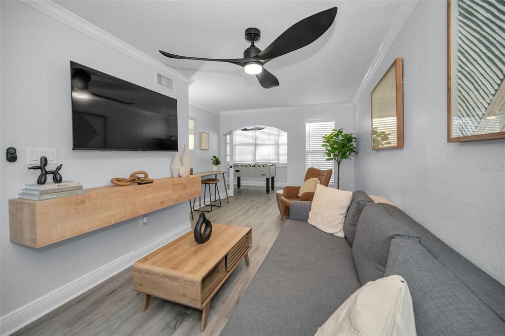 19417 Gulf Boulevard, Unit F207 Indian Rocks Beach, FL 33785 - Photo 18 of 56 a living room with furniture and a flat screen tv