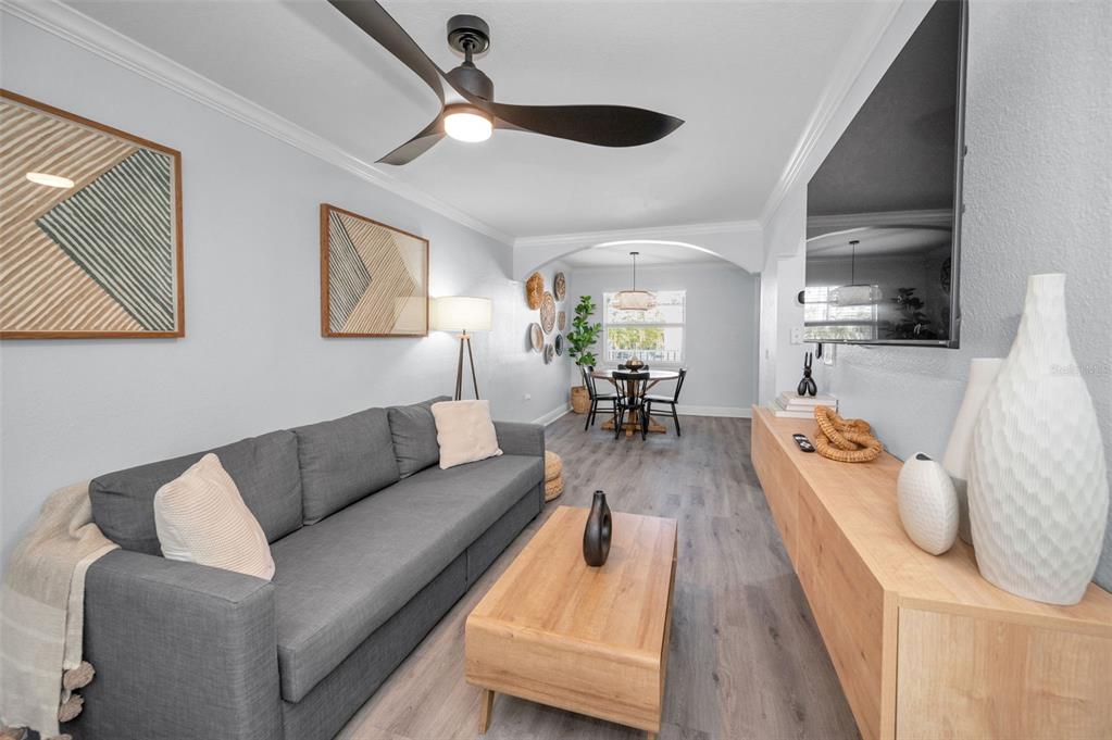 19417 Gulf Boulevard, Unit F207 Indian Rocks Beach, FL 33785 - Photo 22 of 56 a living room with furniture and a chandelier