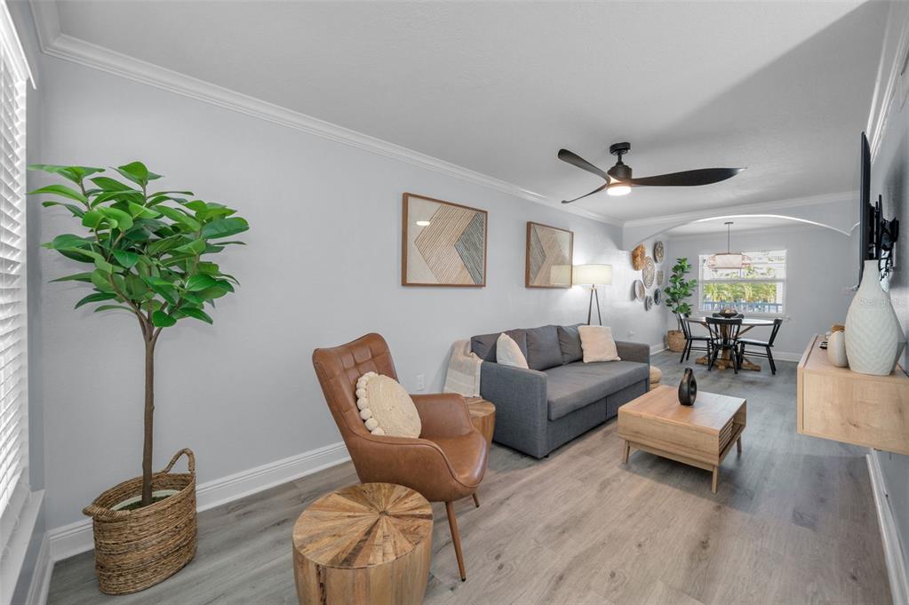 19417 Gulf Boulevard, Unit F207 Indian Rocks Beach, FL 33785 - Photo 23 of 56 a living room with furniture and a potted plant