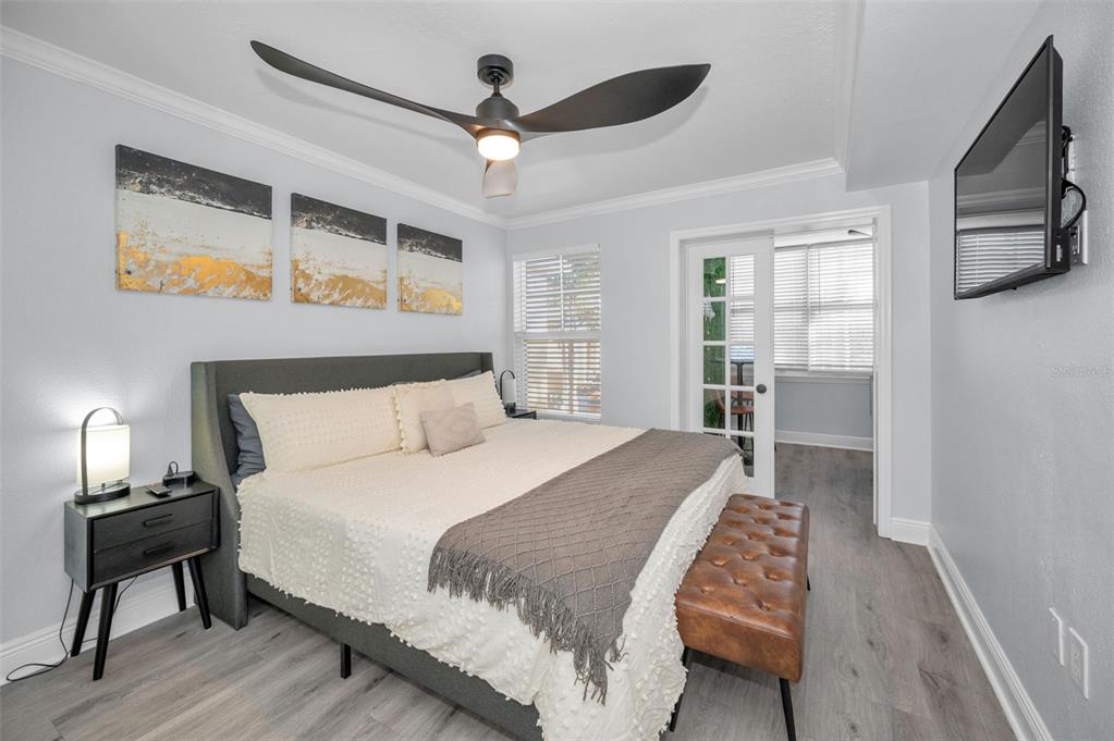 19417 Gulf Boulevard, Unit F207 Indian Rocks Beach, FL 33785 - Photo 24 of 56 a bedroom with a large bed a flat tv screen and dresser