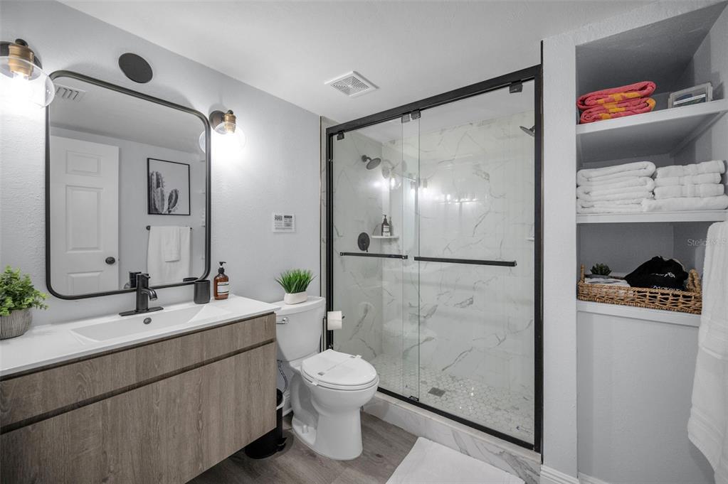 19417 Gulf Boulevard, Unit F207 Indian Rocks Beach, FL 33785 - Photo 26 of 56 a bathroom with a sink and a mirror