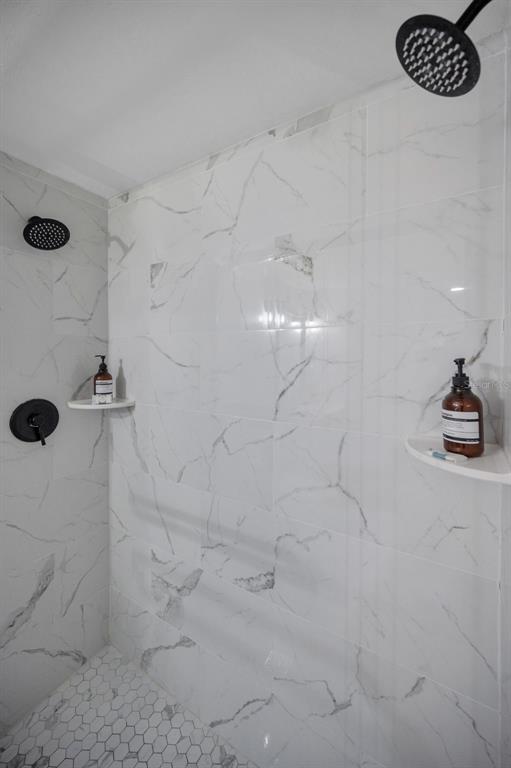 19417 Gulf Boulevard, Unit F207 Indian Rocks Beach, FL 33785 - Photo 27 of 56 a bathroom with a shower