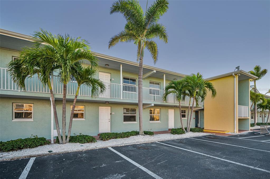 19417 Gulf Boulevard, Unit F207 Indian Rocks Beach, FL 33785 - Photo 4 of 56 a front view of multiple houses with yard