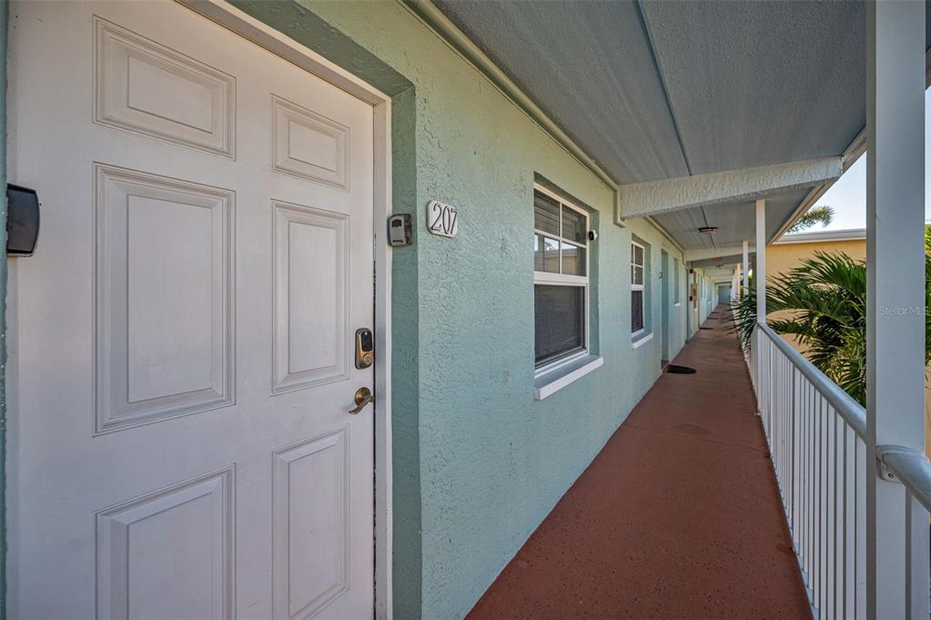 19417 Gulf Boulevard, Unit F207 Indian Rocks Beach, FL 33785 - Photo 6 of 56 a view of a house with porch