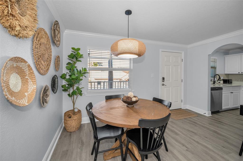 19417 Gulf Boulevard, Unit F207 Indian Rocks Beach, FL 33785 - Photo 8 of 56 a view of a dining room with furniture and wooden floor