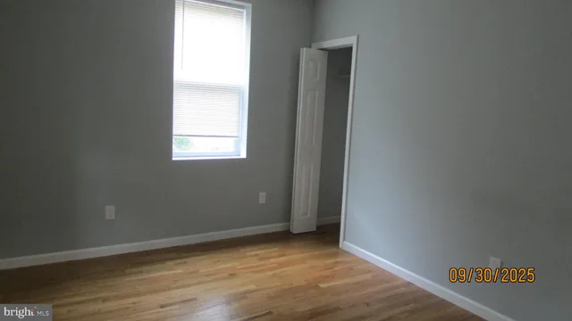 an empty room with windows and closet